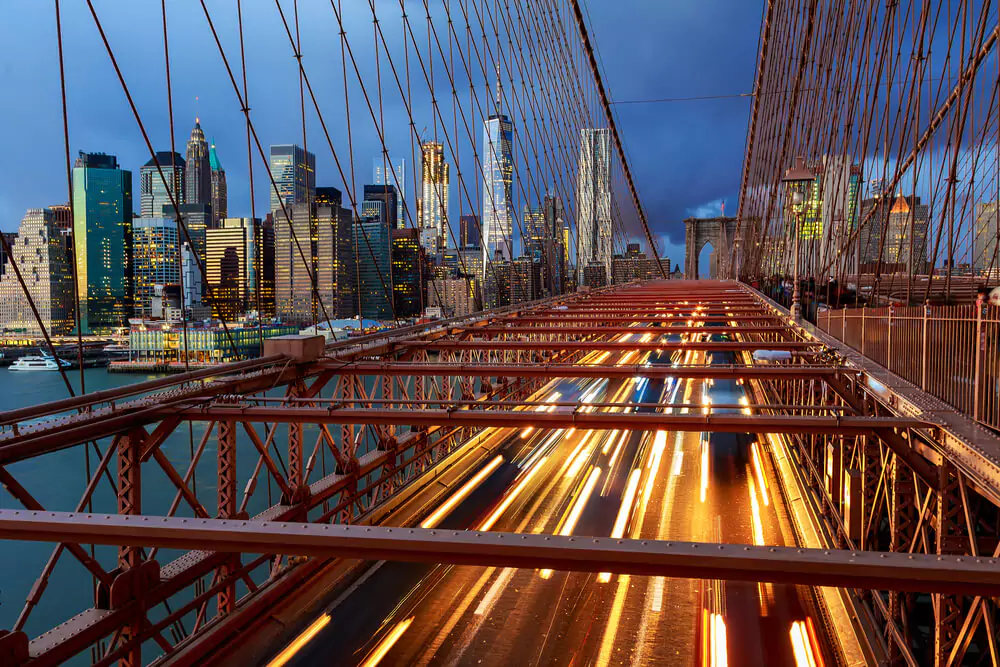 View of Brooklyn Bridge at night with car traffic Brooklyn Bridge at night