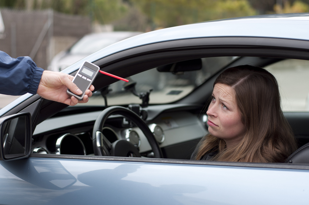 young female driver due to being subject to test for alcohol content with use of breathalyzer