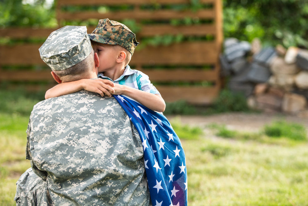 Military man father hugs son