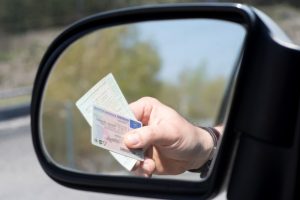 man-shows-drivers-license-and-vehicle-license-during-a-check