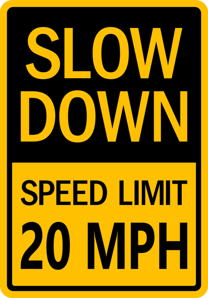 speed limit signs on the side of a road